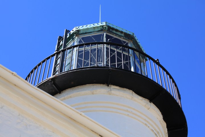 A lighthouse tower as viewed from the ground looking up.
