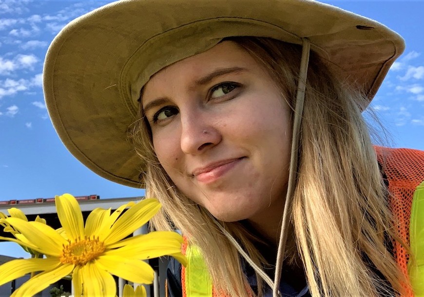 IAP Brooke Wilder admiring the spring bloom while removing invasive plants with the Weed Warriors.