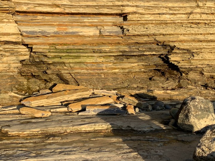 Broken pieces of sandstone cliff on ground