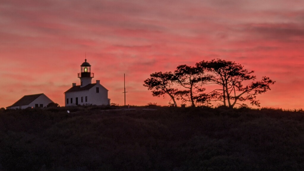 Lighthouse with orange sky at sunset