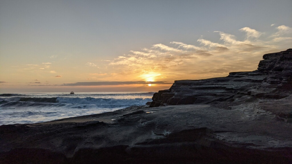 Sunset view of ocean and sandstone cliffs