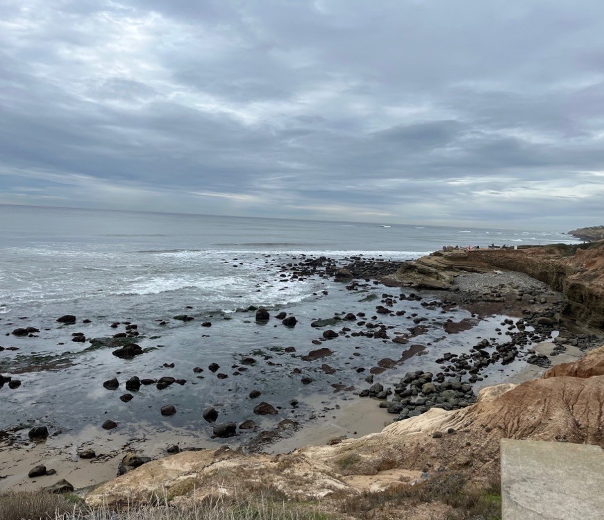 Gray clouds above a rocky shoreline