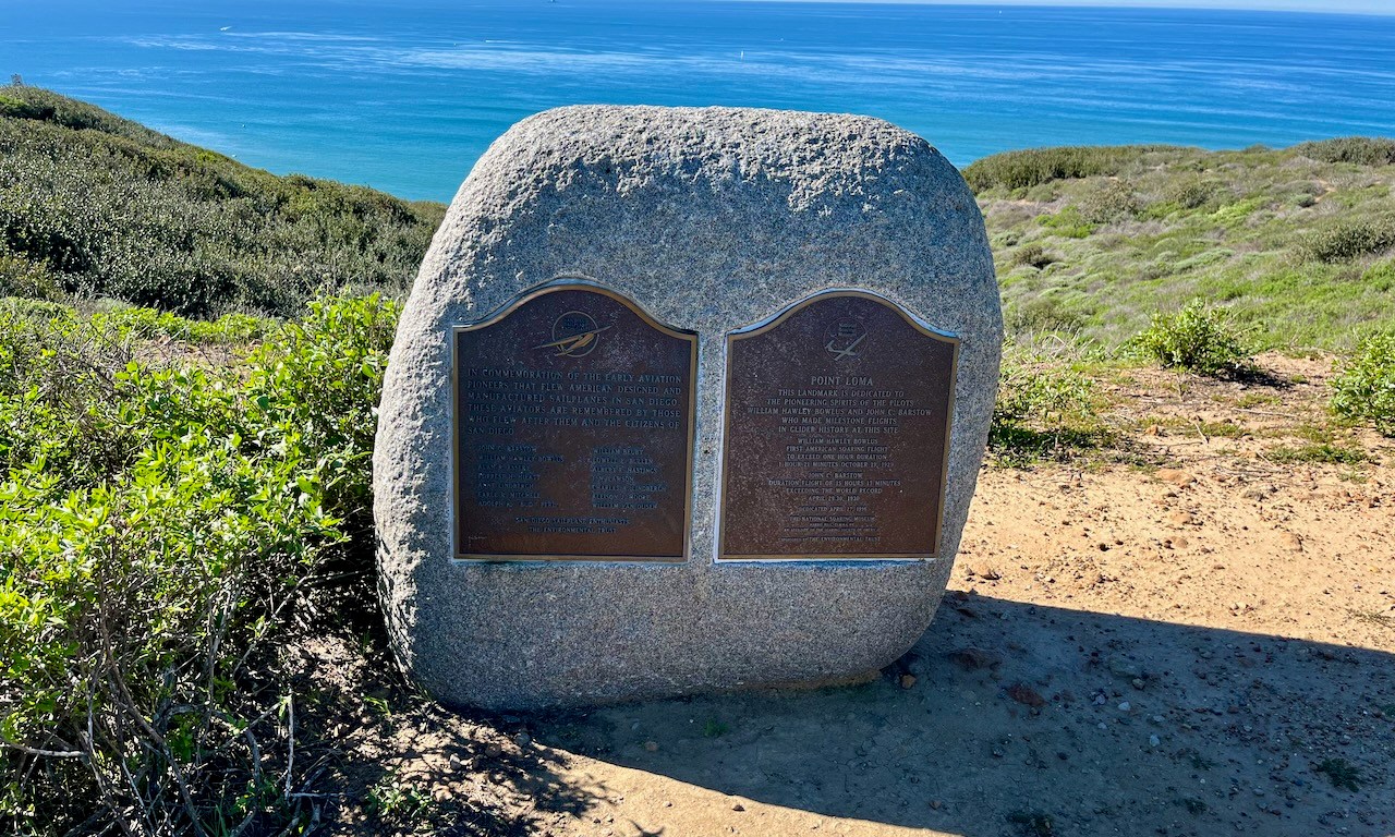 Plaques on a hill overlooking the ocean, describing early aviation pioneers