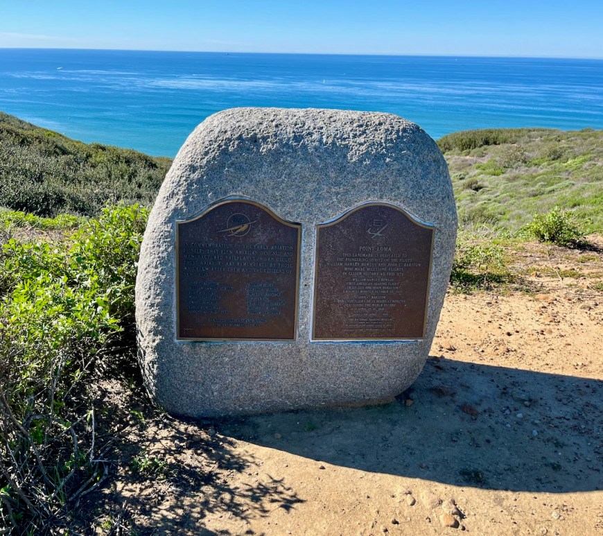 Plaques on a hill overlooking the ocean, describing early aviation pioneers