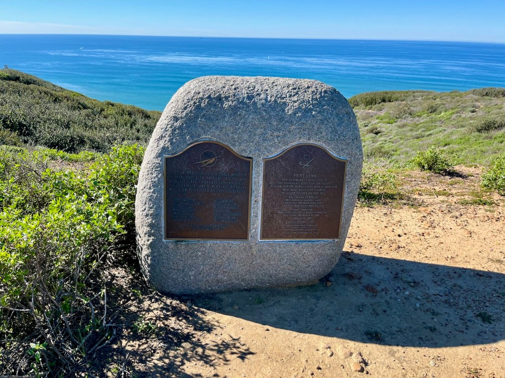 Plaques on a hill overlooking the ocean, describing early aviation pioneers