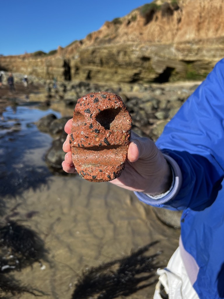 A weathered brick that looks like it has a face on it.