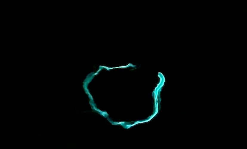 A bright glowing worm against a black background