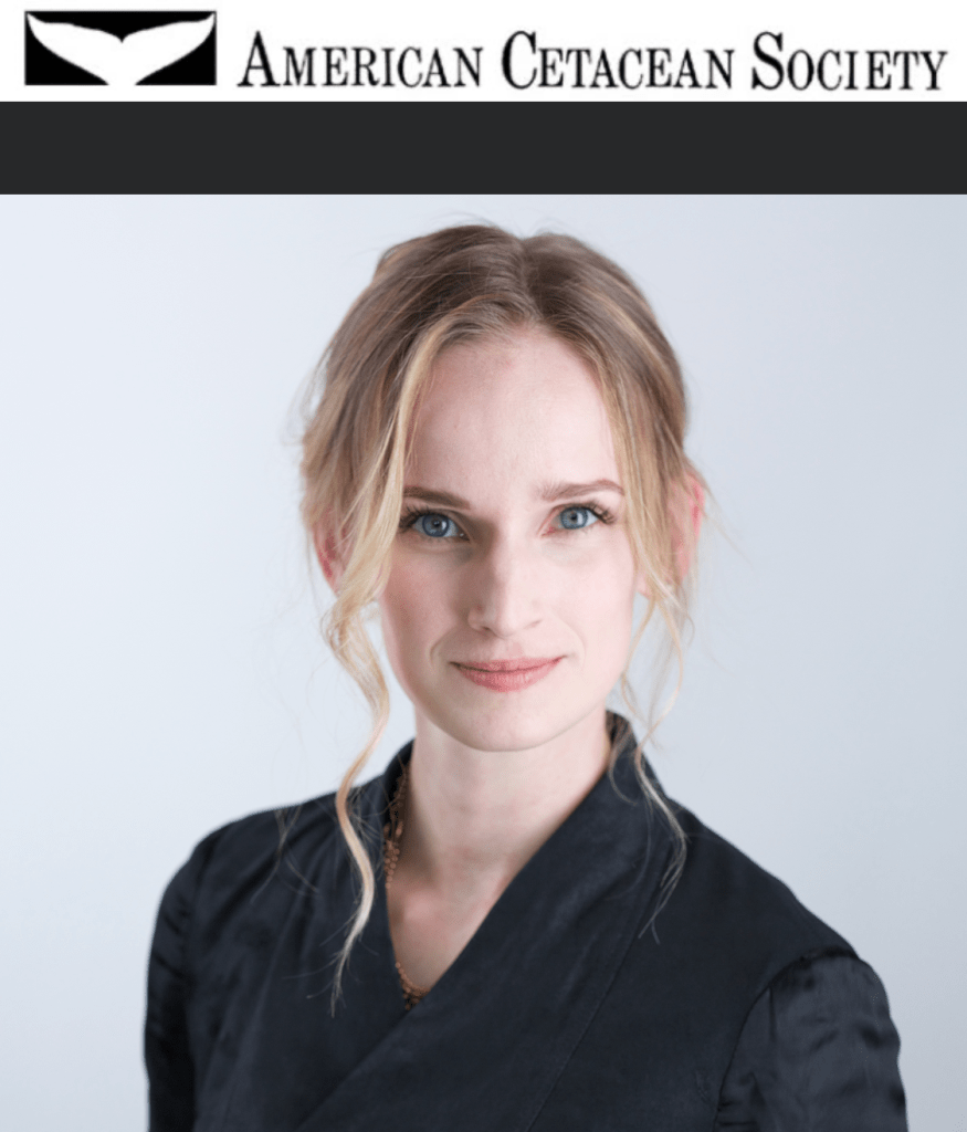 Woman with blonde hair in a black top, with "American Cetacean Society" logo above her.